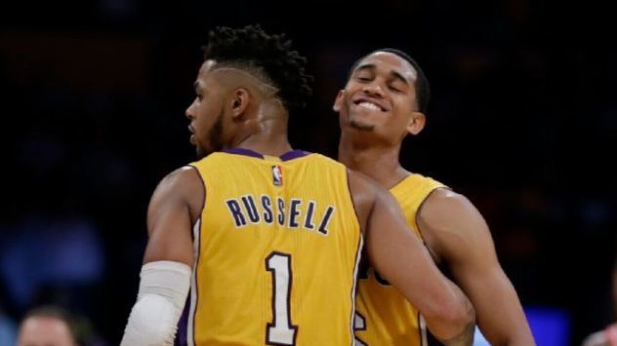 Lakers teammates Jordan Clarkson and D'Angelo Russell embrace after beating the Houston Rockets 120-114 at Staples Center on Oct. 26, 2016.