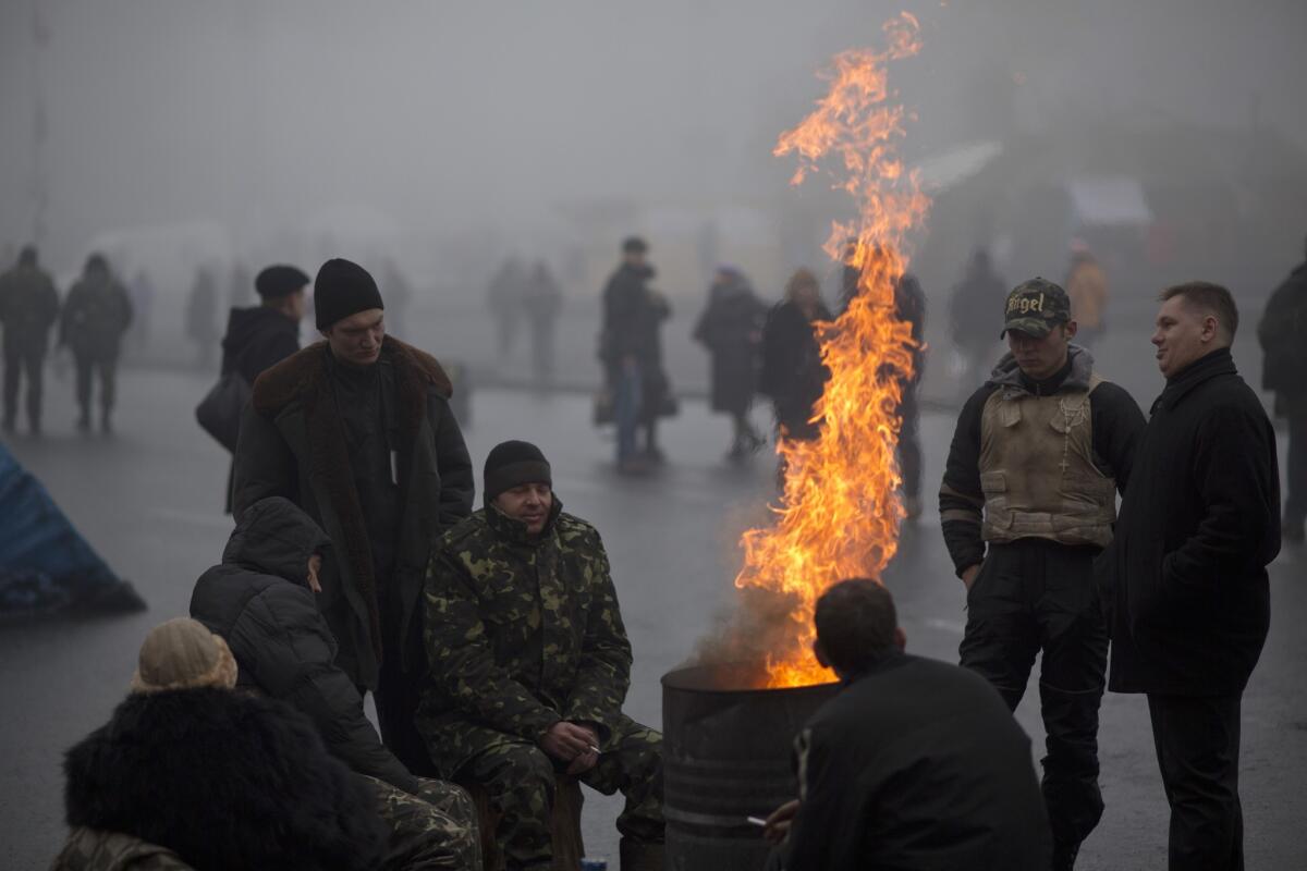 Ukrainians warm themselves next to a fire in Kiev's Independence Square.