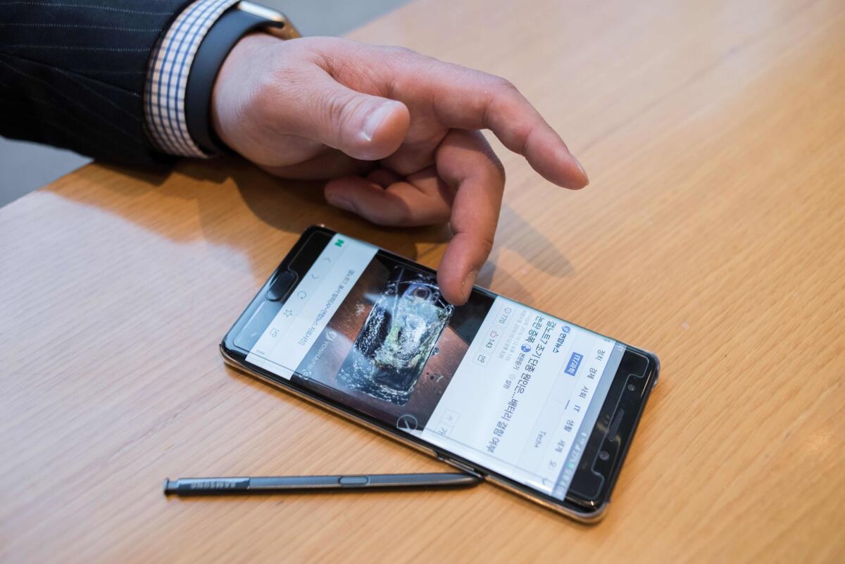 A Samsung phone at a company store near the firm's headquarters in Seoul shows a photo of a fire-damaged Galaxy Note 7.