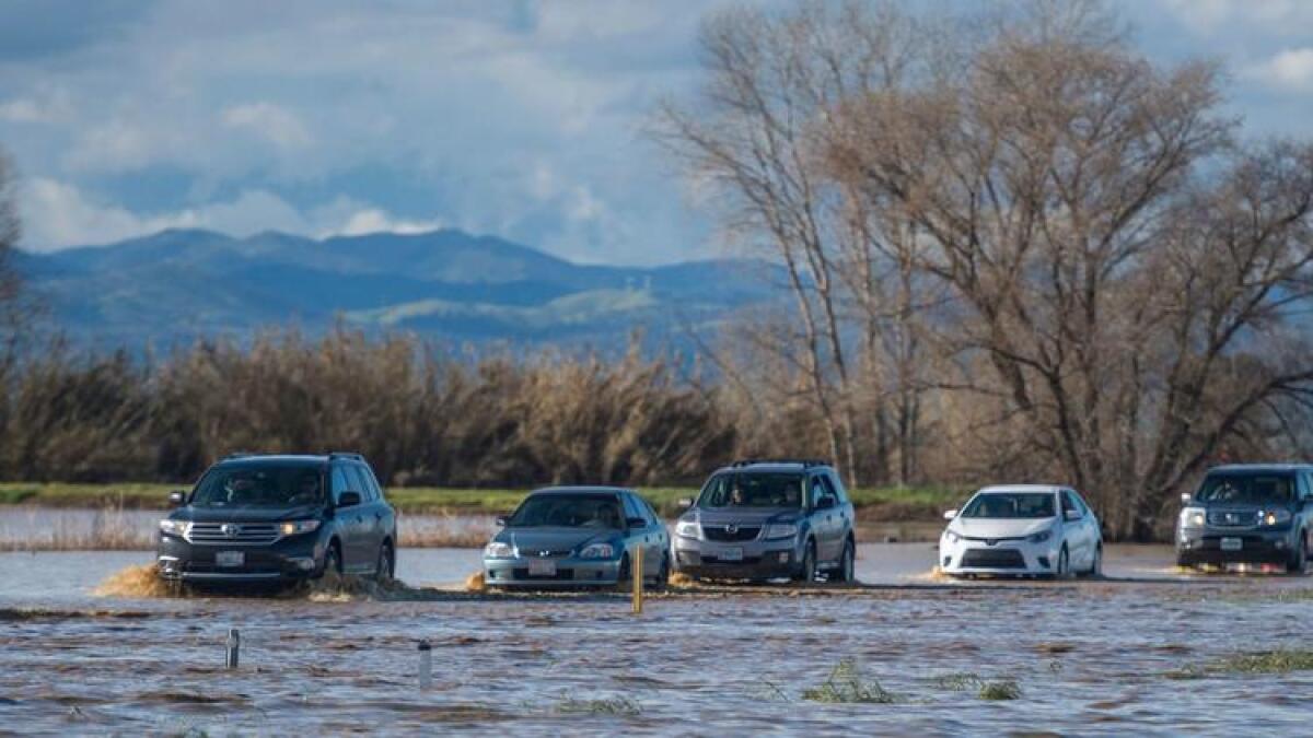Drivers traverse a flooded section of I-5 in Northern California earlier this year.