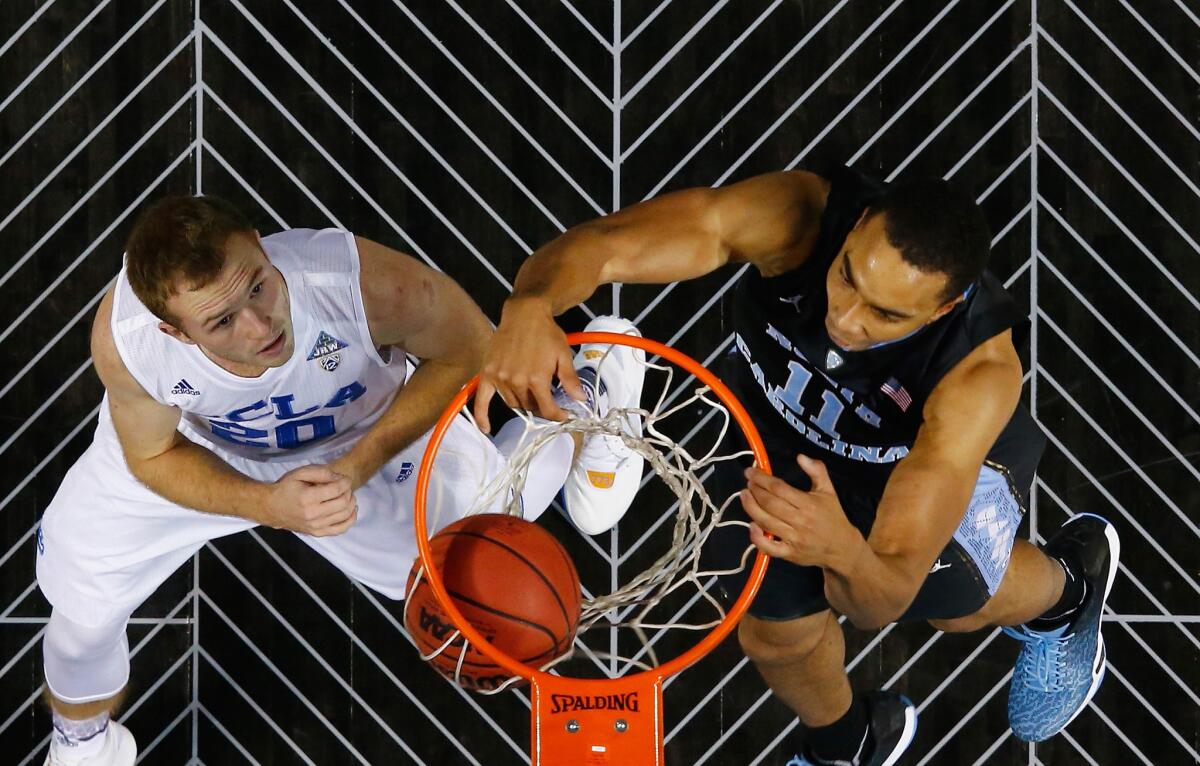 North Carolina forward Brice Johnson dunks against UCLA guard Bryce Alford during a game at the CBS Sports Classic at the Barclays Center.
