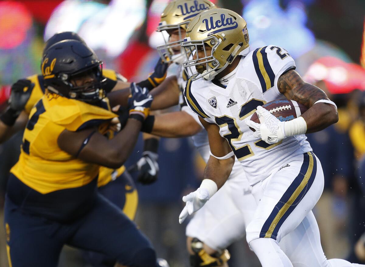 UCLA running back Nate Starks tries to bound outside against California's defense during the first half.