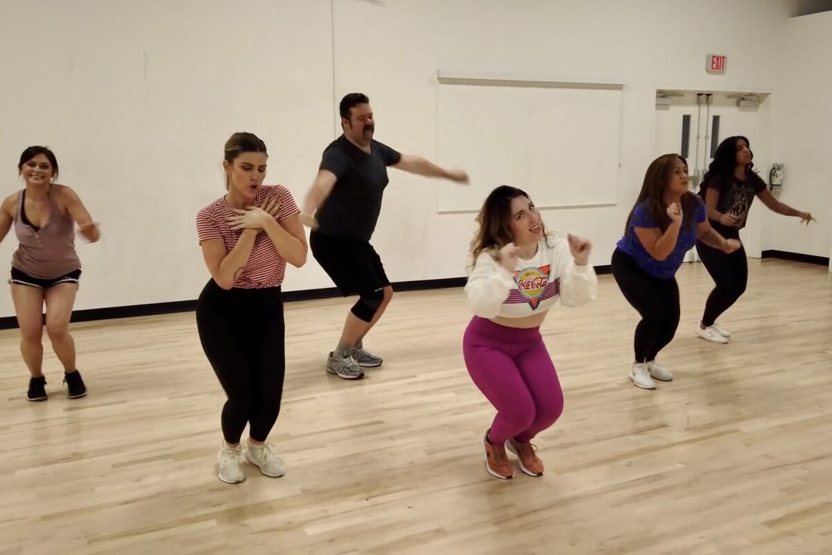 A dance class tries out some moves.