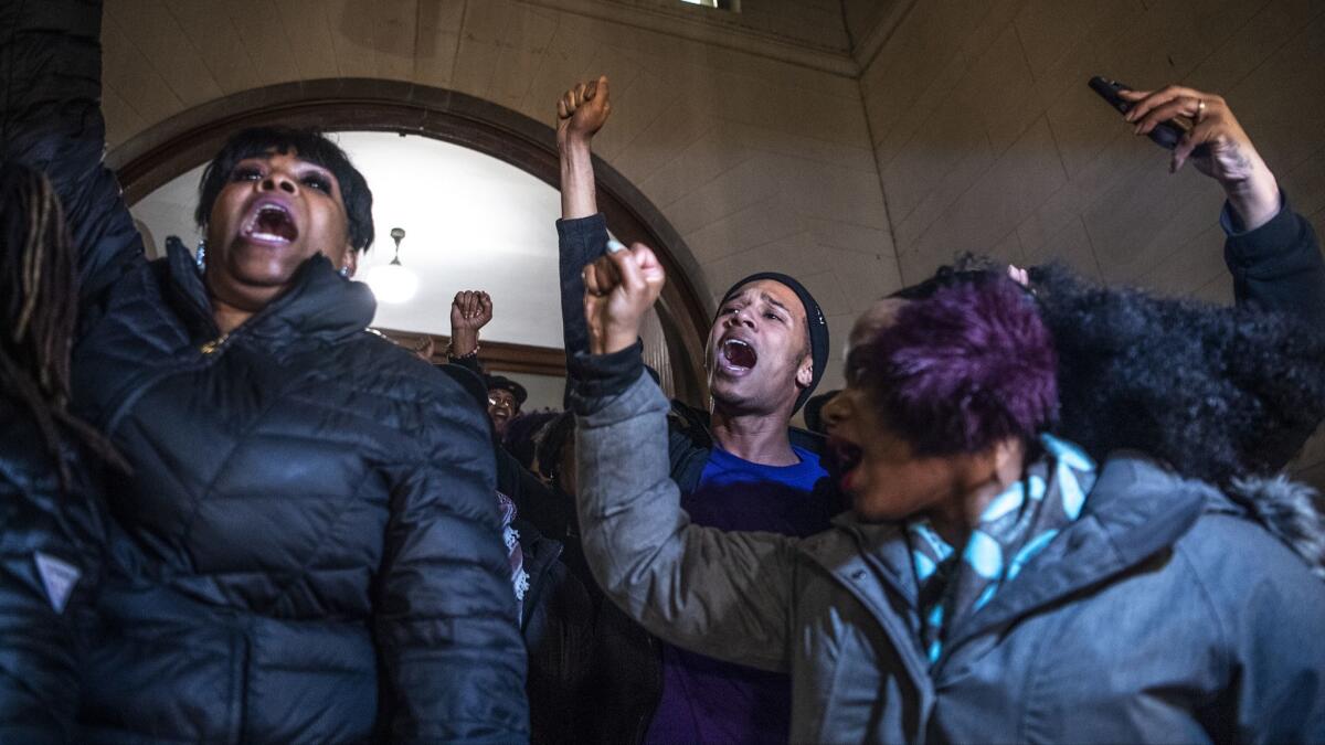 Khalil Darden, 18, center, of Penn Hills, Pa., and Pennsylvania State Rep. Summer Lee, right, protest Friday at the Allegheny County Courthouse in Pittsburgh, after the not guilty verdict in the homicide trial of former Police Officer Michael Rosfeld.
