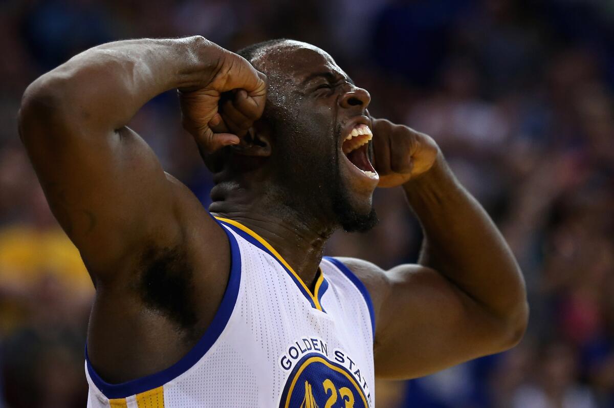 Warriors forward Draymond Green celebrates after scoring a basket while being fouled during a game against Trail Blazers on April 3.