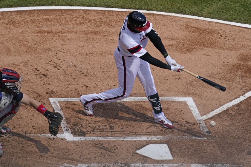 Chicago White Sox's Luis Robert hits a single on a ground ball to Cleveland Indians third baseman Jose Ramirez during the first inning of a baseball game in Chicago, Sunday, May 2, 2021. (AP Photo/Nam Y. Huh)