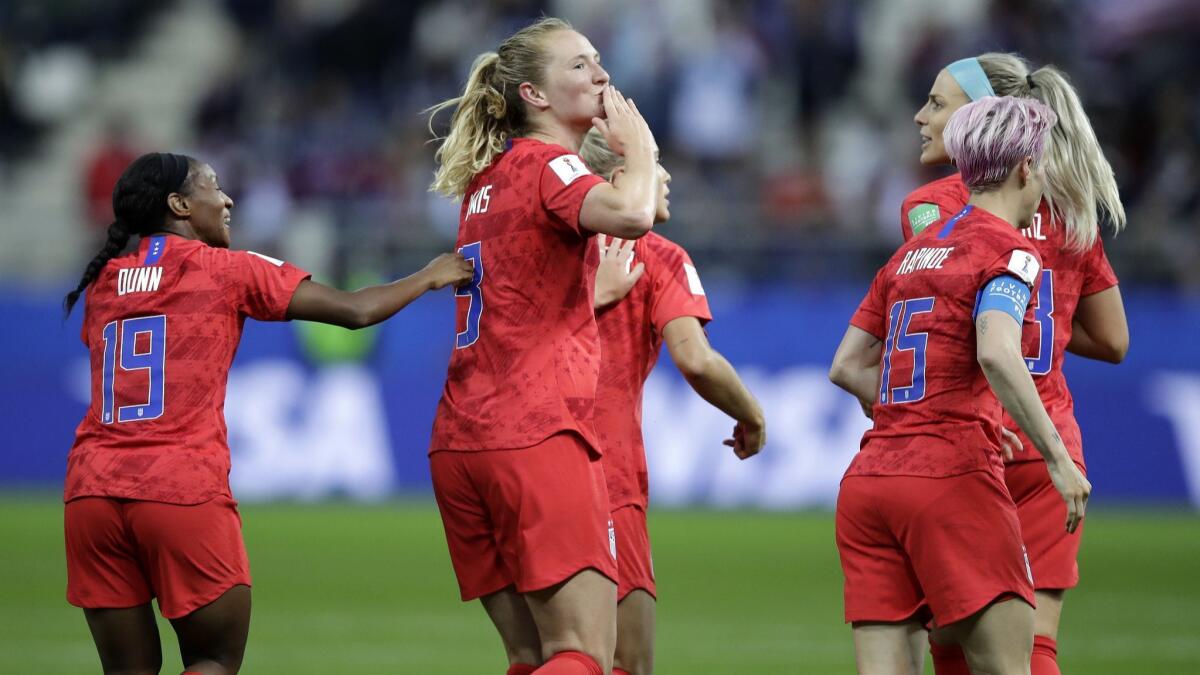 Samantha Mewis, center, celebrates with teammates after she scored the United States' fourth goal against Thailand in the team's World Cup opener.
