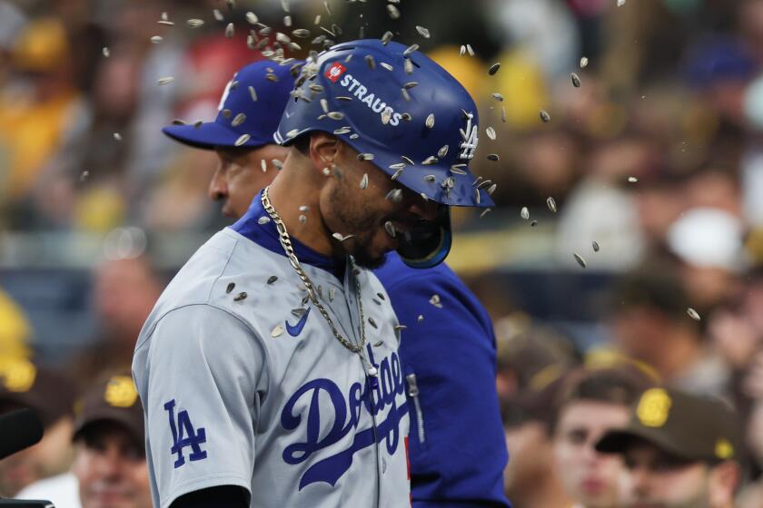 SAN DIEGO, CALIFORNIA - OCTOBER 09: Mookie Betts #50 of the Los Angeles Dodgers is showered.