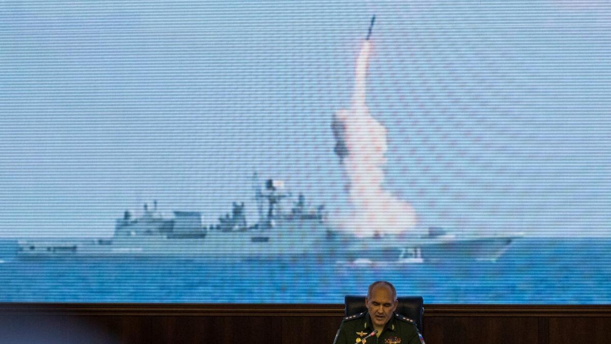 Col. Gen. Sergei Rudskoi of the Russian General Staff attends a briefing Sept. 6 in Moscow. Onscreen is a Russian missile being launched at Islamic State positions.