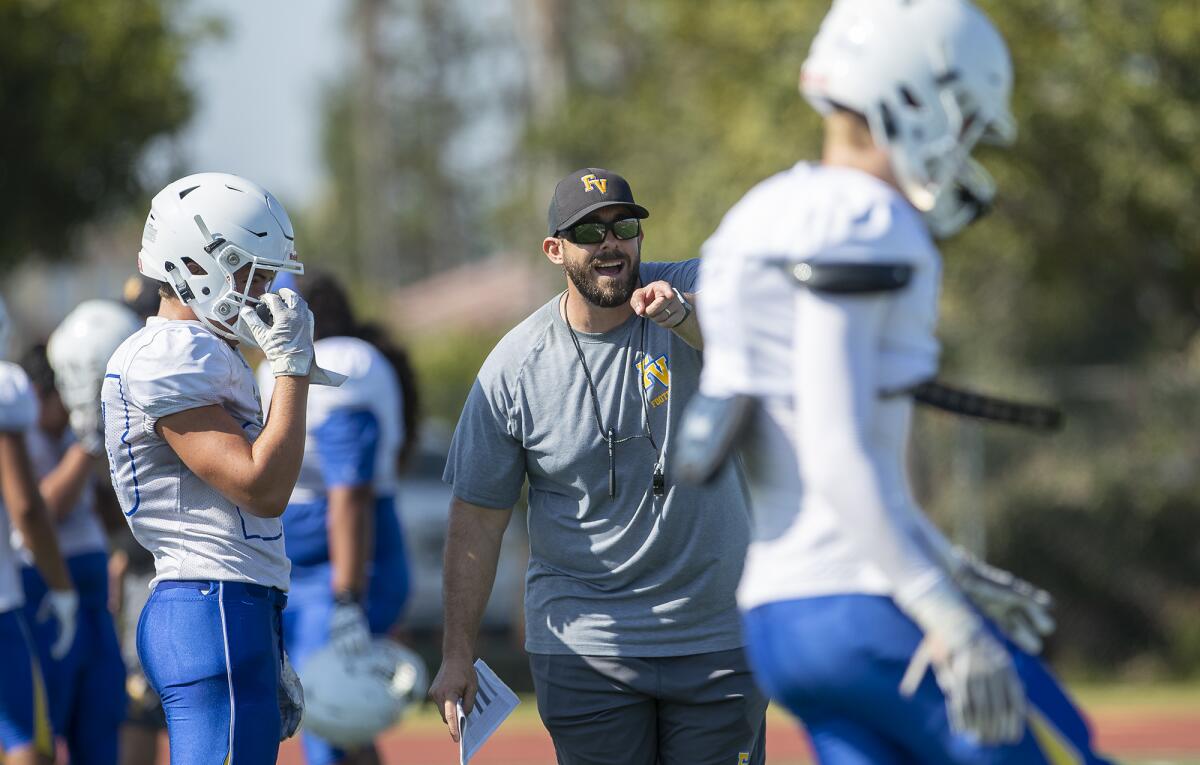 Coach Chris Anderson, shown giving instructions to his Fountain Valley team on Aug. 8, and his Barons fall behind early in Friday's season opener and suffer a 27-13 loss at Wildomar Elsinore.