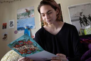 Kira Stanley, 15, in her room at her Encinitas home Friday reading some of the cards and letters she has received. photo by Bill Wechter