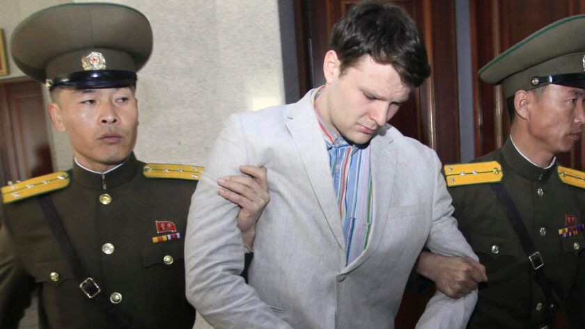 American student Otto Warmbier is escorted at the Supreme Court in Pyongyang, North Korea, on March 16, 2016.