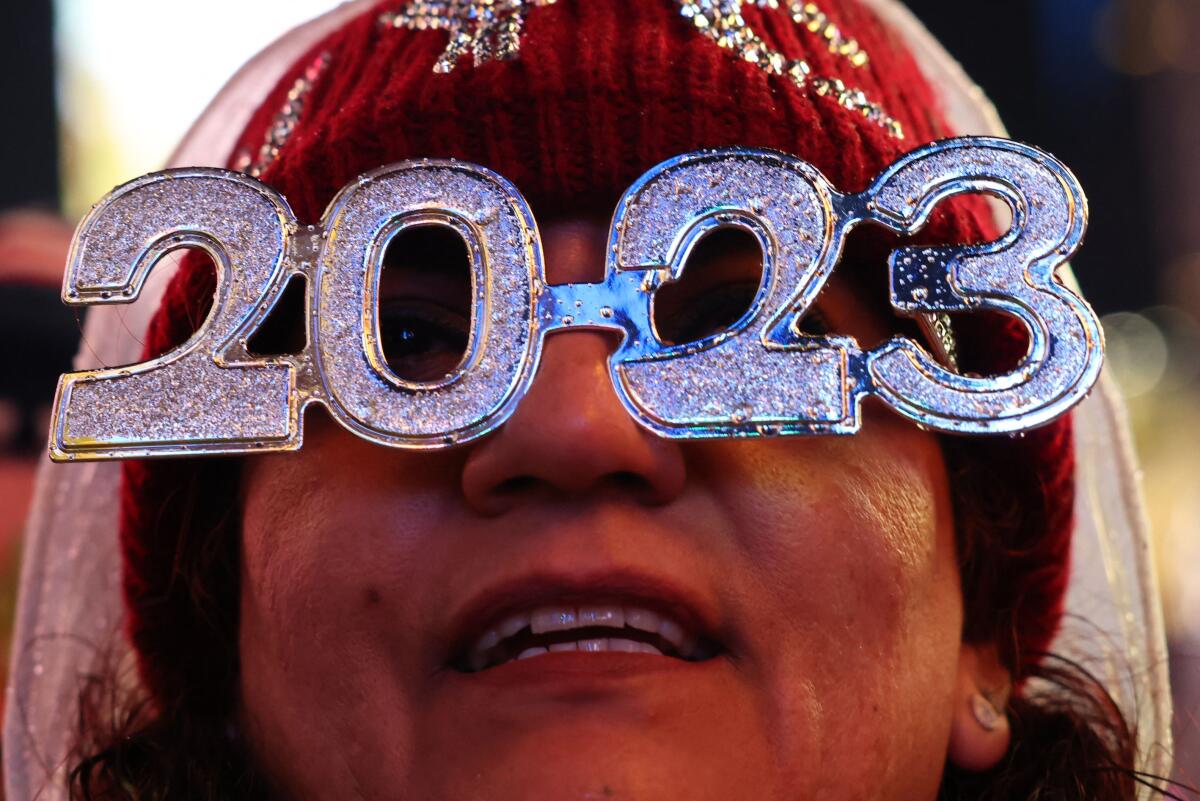 New Year's reveler in glitter glasses 