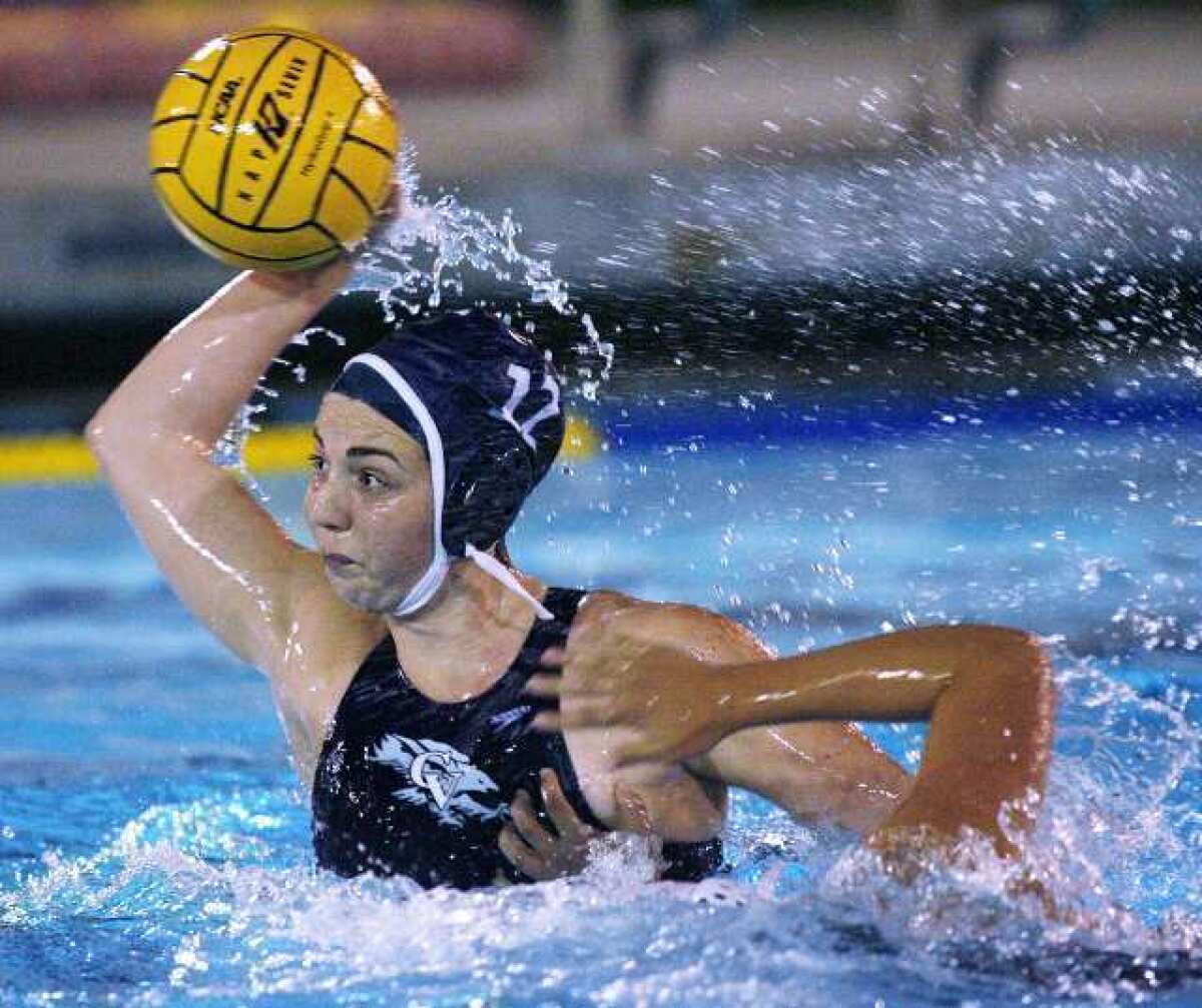Crescenta Valley's Shannon Hovanesian rises with the ball for a goal-scoring shot after a breakaway against Downey in the second quarter of a CIF Southern Section Division V first-round girls' water polo playoff game at PCC in Pasadena on Wednesday, February 13, 2013.