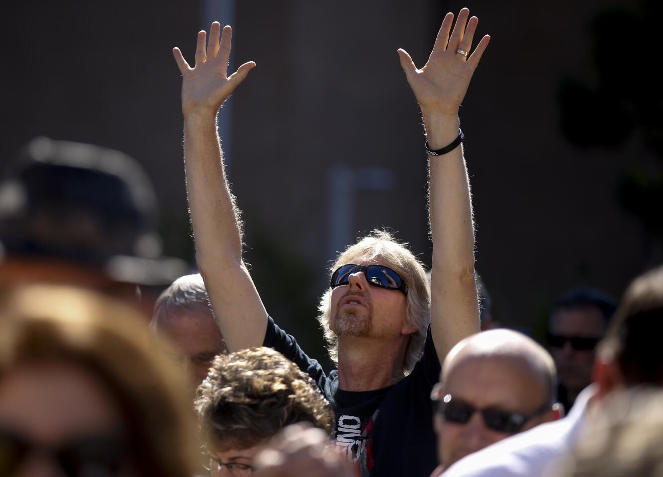 Members of the community pray outside the El Cajon Police Department.