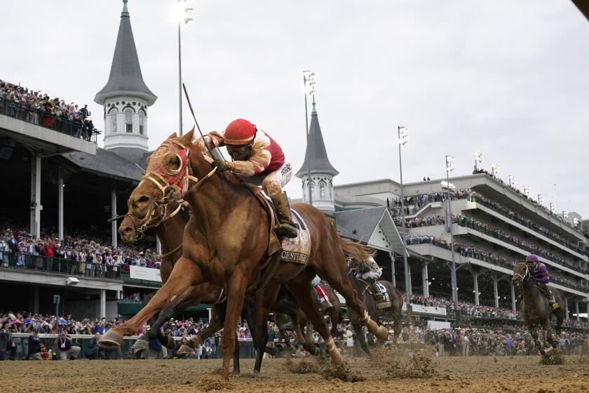 FILE - Rich Strike, with Sonny Leon aboard, crosses the finish line to win the 148th running of the Kentucky Derby horse race at Churchill Downs Saturday, May 7, 2022, in Louisville, Ky. Churchill Downs is planning a series of celebrations and fan experiences leading up to the milestone 150th Kentucky Derby in May 2024. (AP Photo/Jeff Roberson, File)