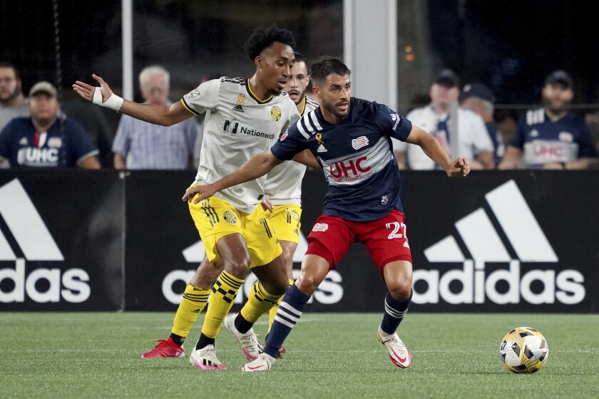 FILE - New England Revolution midfielder Carles Gil (22) controls the ball ahead of Columbus Crew midfielder Marlon Hairston (17) during the first half of a MLS soccer match on Sept. 18, 2021, in Foxborough, Mass. Gill has been named Major League Soccer's Player of the Year. (AP Photo/Mary Schwalm, File)