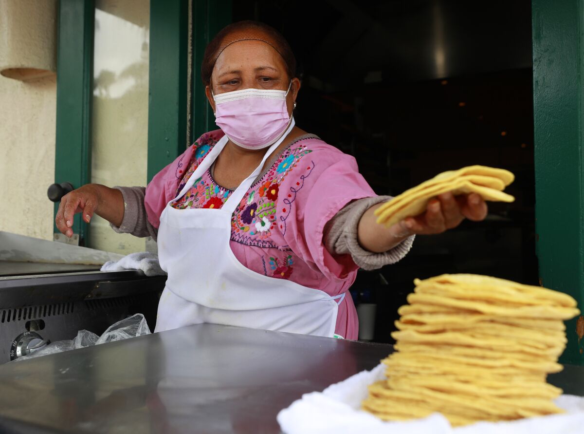 Norma Cedano makes tortillas at Cafe Coyote in Old Town on Monday, May 17, 2021 in San Diego, CA. 