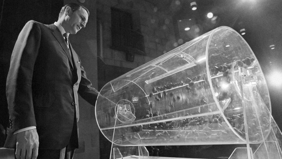 Draft Director Curtis W. Tarr spins a Plexiglas drum during the Selective Service lottery in Washington on Feb. 2, 1972.