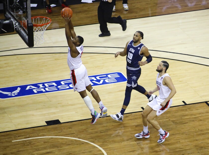 SDSU's Lamont Butler slams the ball against Utah State during the Mountain West tournament championship game last March.