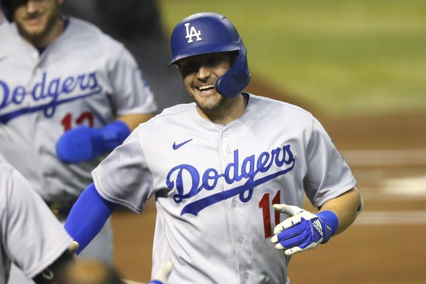 Los Angeles Dodgers' A.J. Pollock (11) smiles as he celebrates his two-run home run.