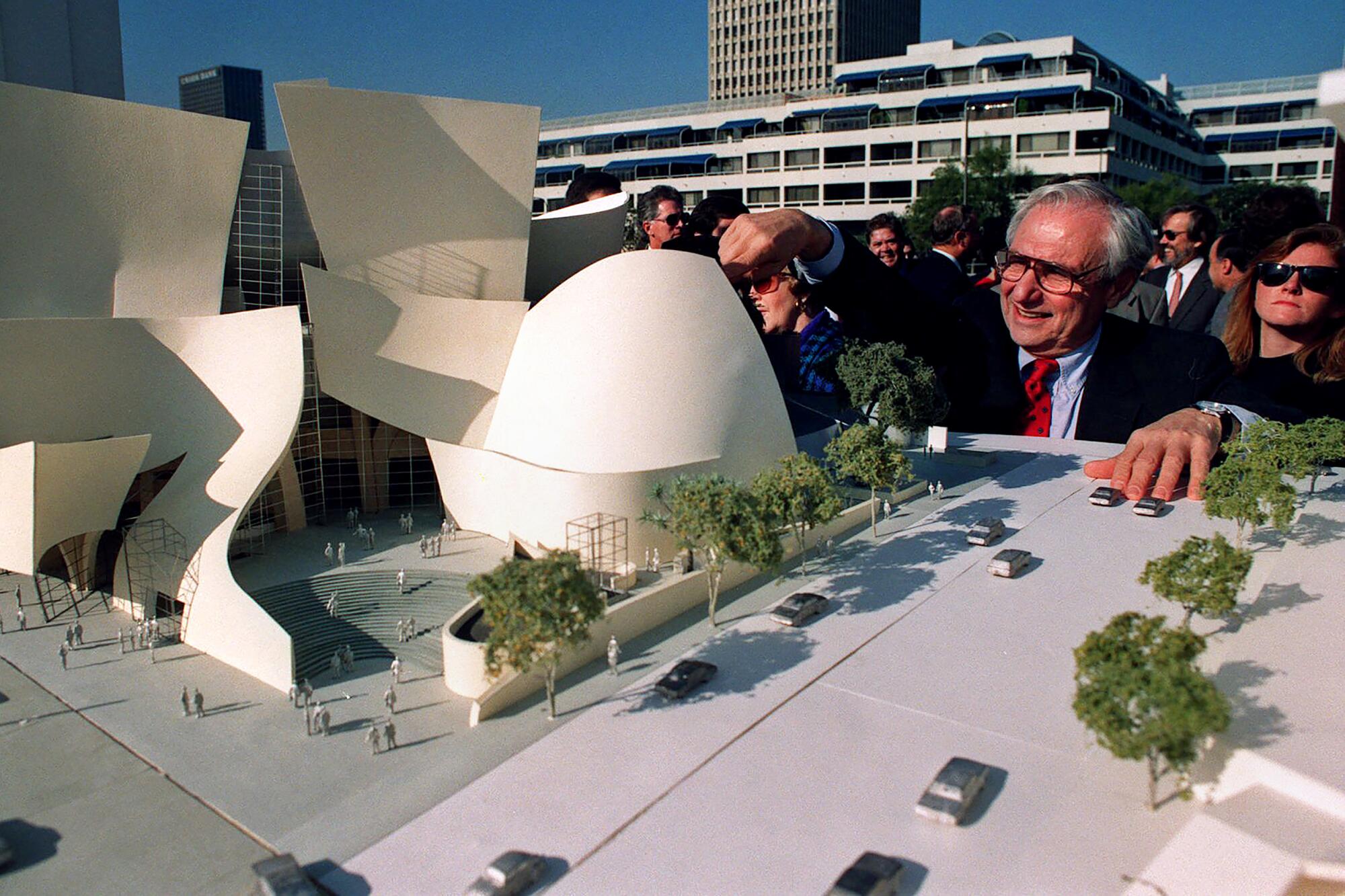 Frank Gehry looks at a model of Walt Disney Concert Hall during groundbreaking ceremonies in 1992.