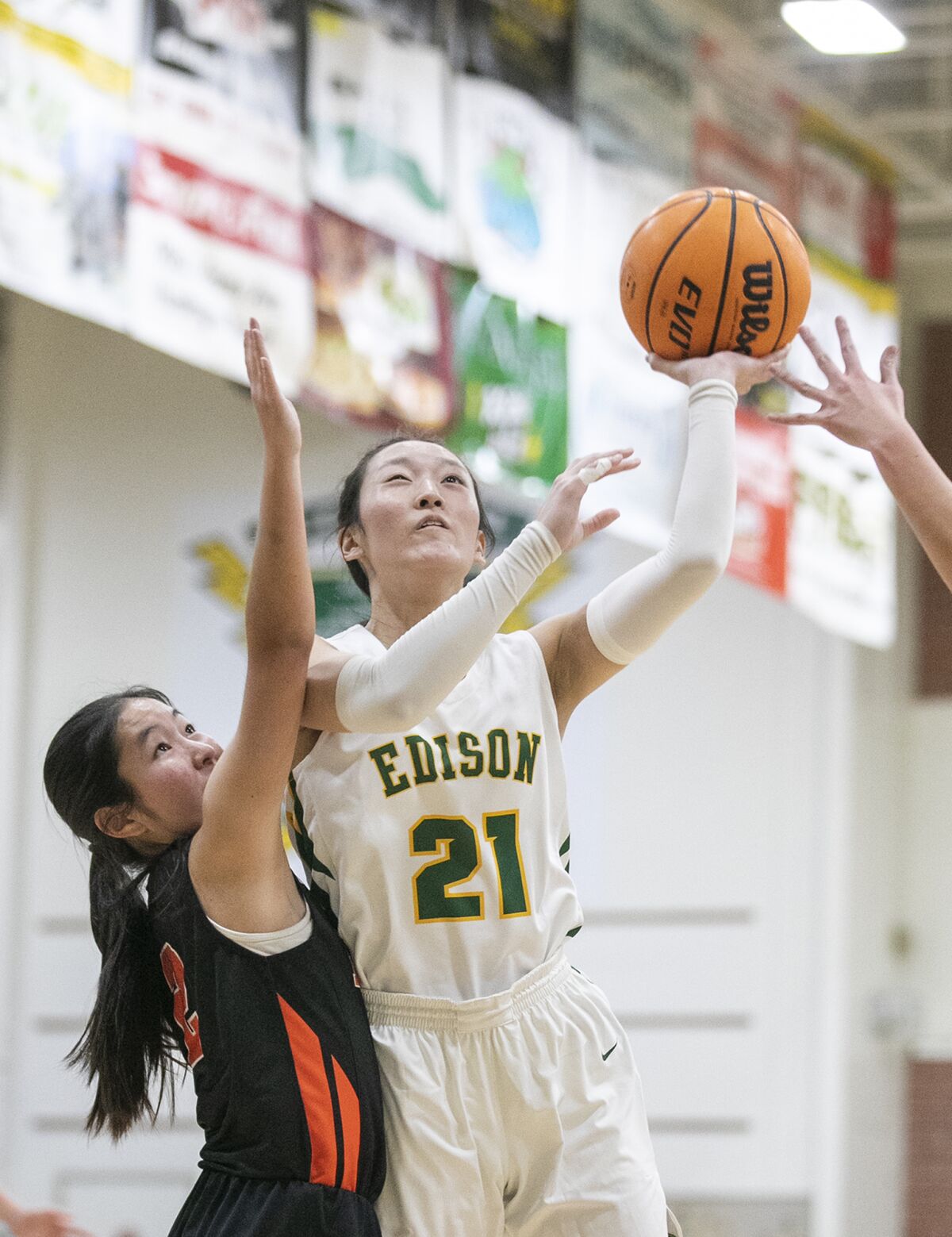 Edison's Bailey Chang goes up for a shot against Huntington Beach's Traci Ann Mori during a Wave League game on Thursday.