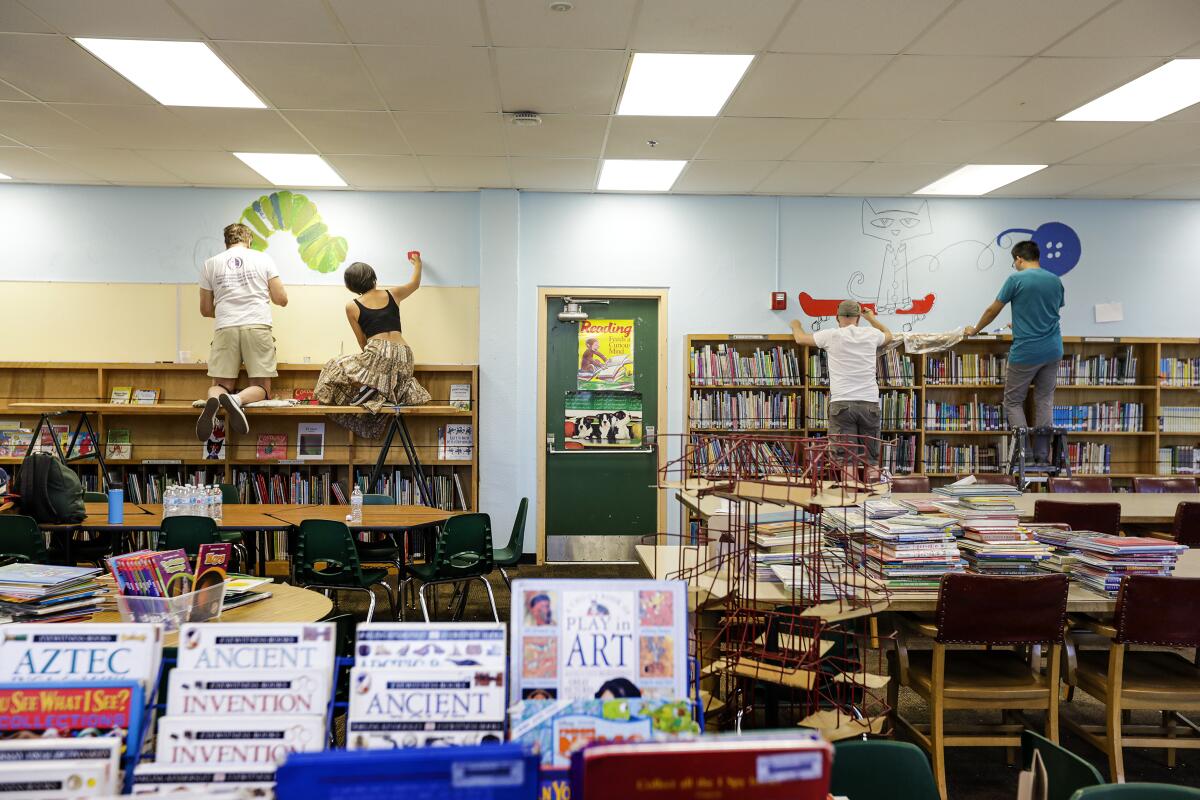 Access Books volunteers refurbish the library at Brockton Avenue Elementary in Los Angeles in 2019.