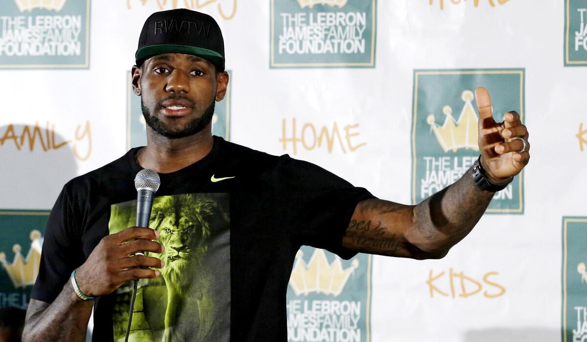 LeBron James answers questions during a news conference at his homecoming event at InfoCision Stadium on Friday in Akron, Ohio.