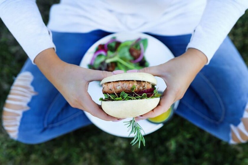 Grilled salmon burger on a potato bun is one of the meals featured on Pure Meal Prep San Diego's menu.