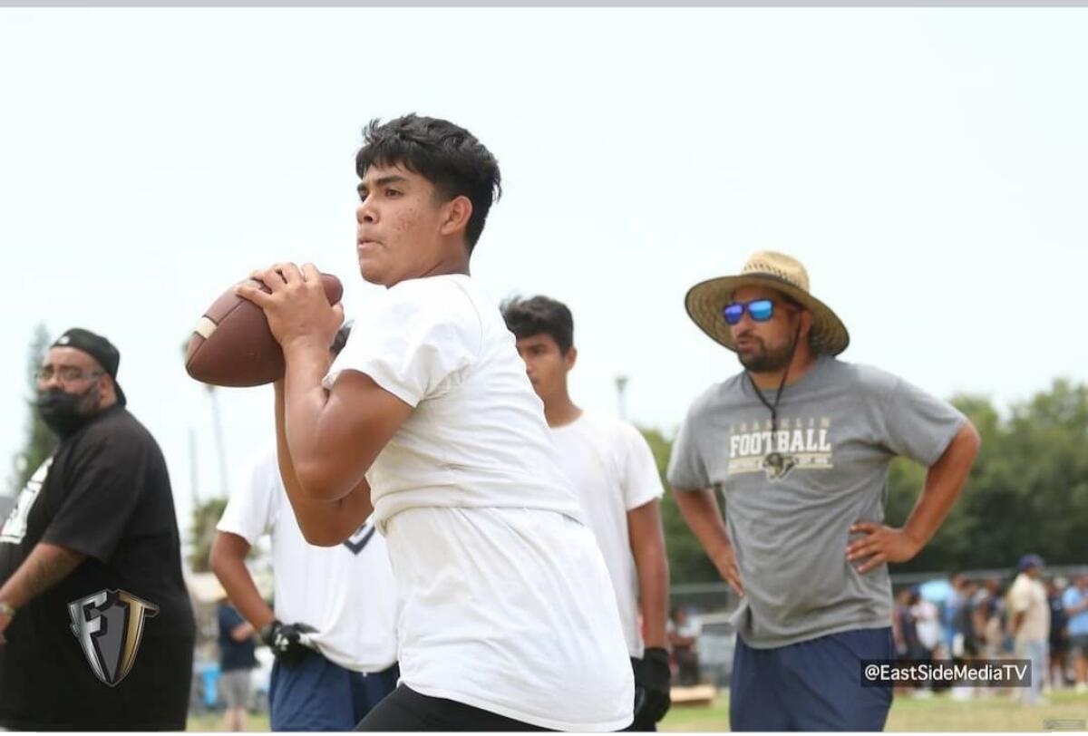 Isaiah Diaz prepares to throw a football.