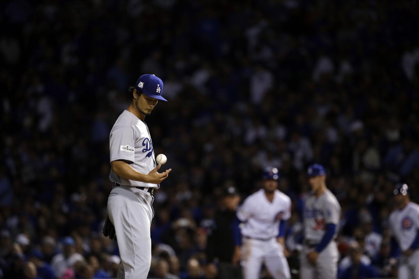 Los Angeles Dodgers starting pitcher Yu Darvish pauses between pitches during the first inning of Game 3 of baseball's National League Championship Series against the Chicago Cubs, Tuesday, Oct. 17, 2017, in Chicago. (AP Photo/Nam Y. Huh)