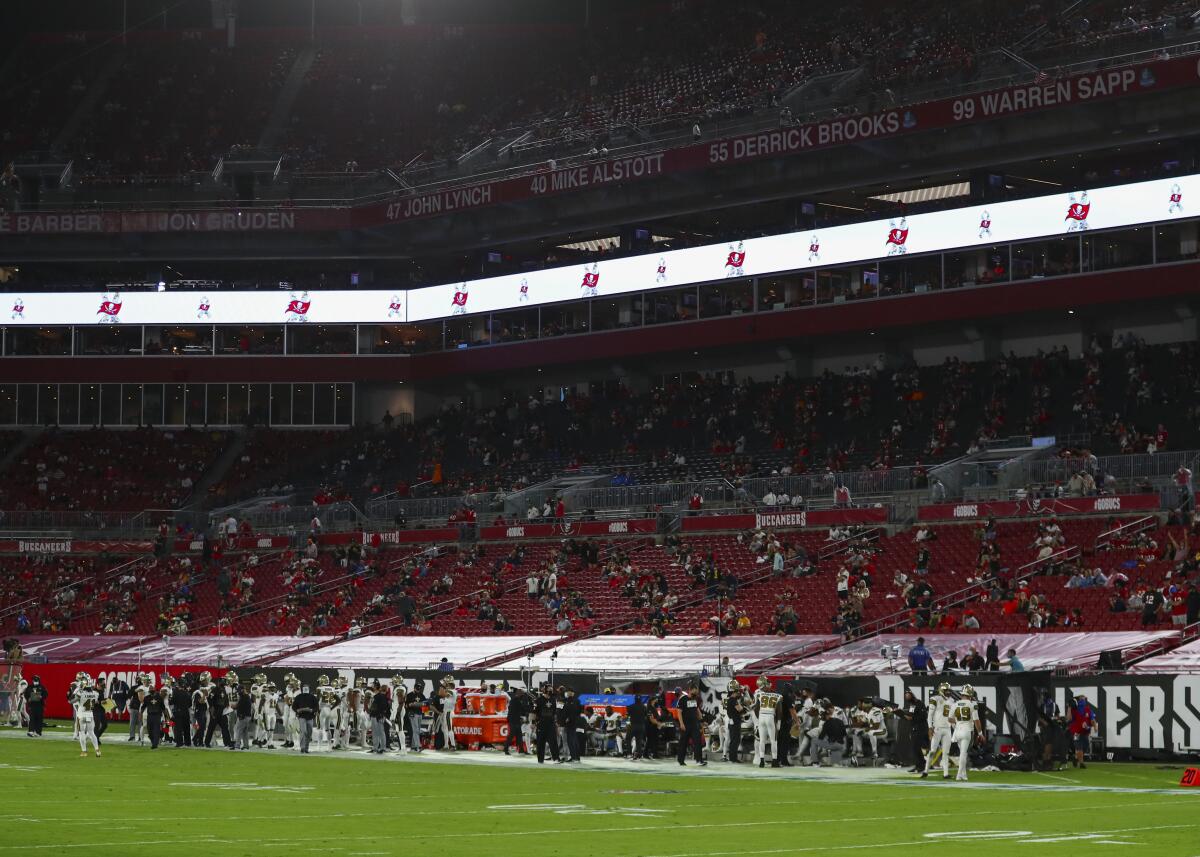 A limited number of fans sit inside Raymond James Stadium for a game between the Saints and Buccaneers.