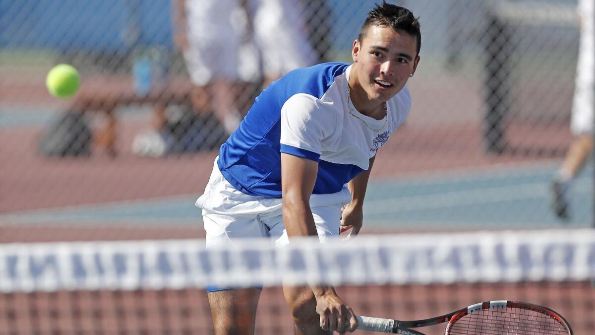 Fountain Valley High's Justin Pham approaches the net during a No. 1 doubles set against Los Alamitos in a Sunset League match on April 17.