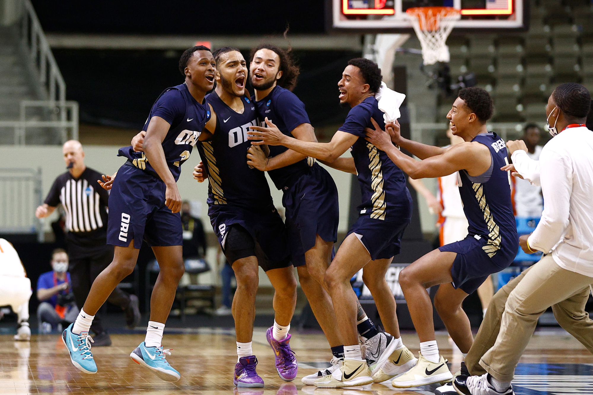 Oral Roberts players (from left) Max Abmas, Kevin Obanor and Kareem Thompson celebrate with teammates.