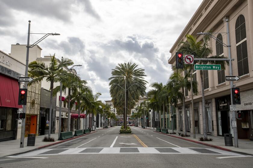 BEVERLY HILLS, CALIF. -- FRIDAY, MARCH 20, 2020: Popular shopping destination Rodeo Drive is all but deserted as retail shops are shuttered in Beverly Hills, Calif., on March 20, 2020. (Brian van der Brug / Los Angeles Times)