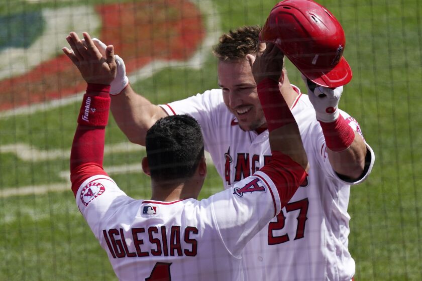 The Angels' Mike Trout is congratulated by teammate José Iglesias after hitting a two-run home run April 6, 2021.