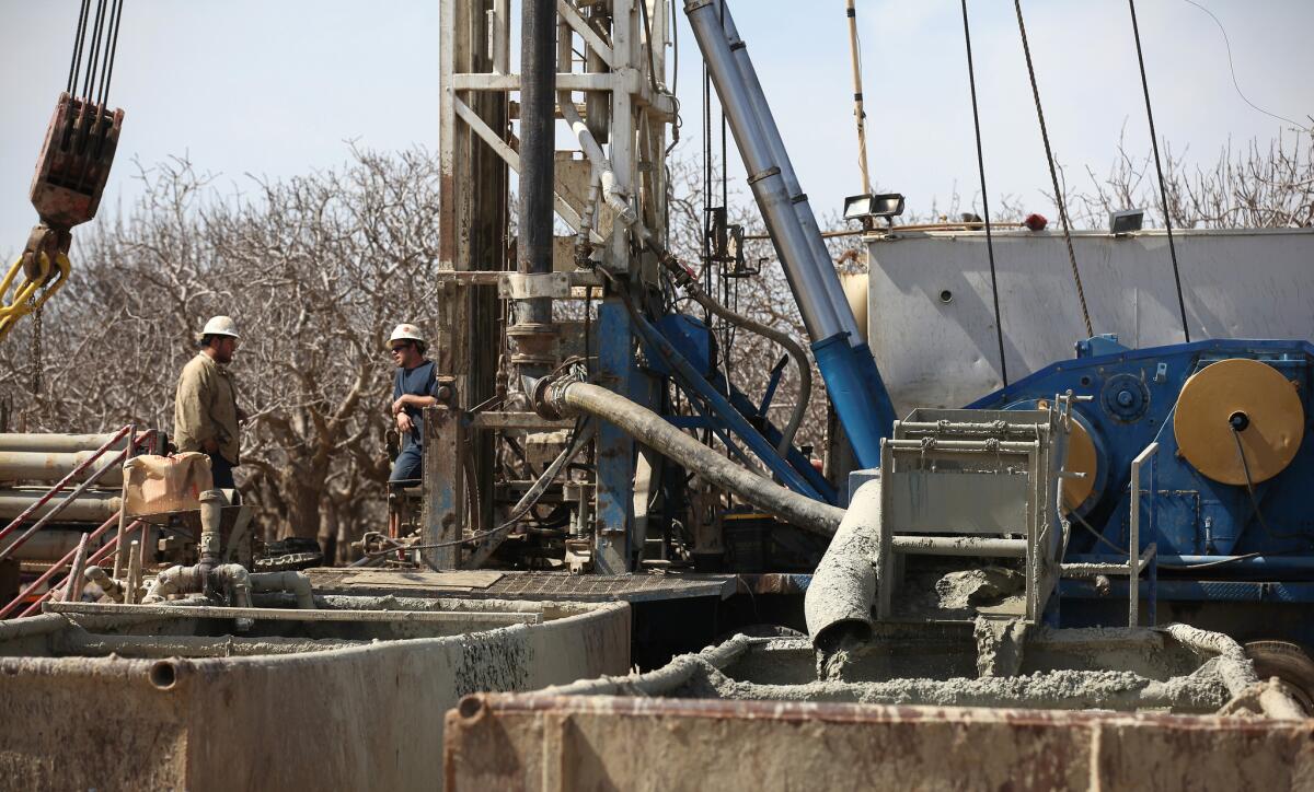 Fluids from the fracking process flow into containment tanks at a oil well near Bakersfield. A new EPA study says that hydraulic fracturing poses risks for drinking water but that the harm is limited. Doubts remain about how comprehensive the study is, however.