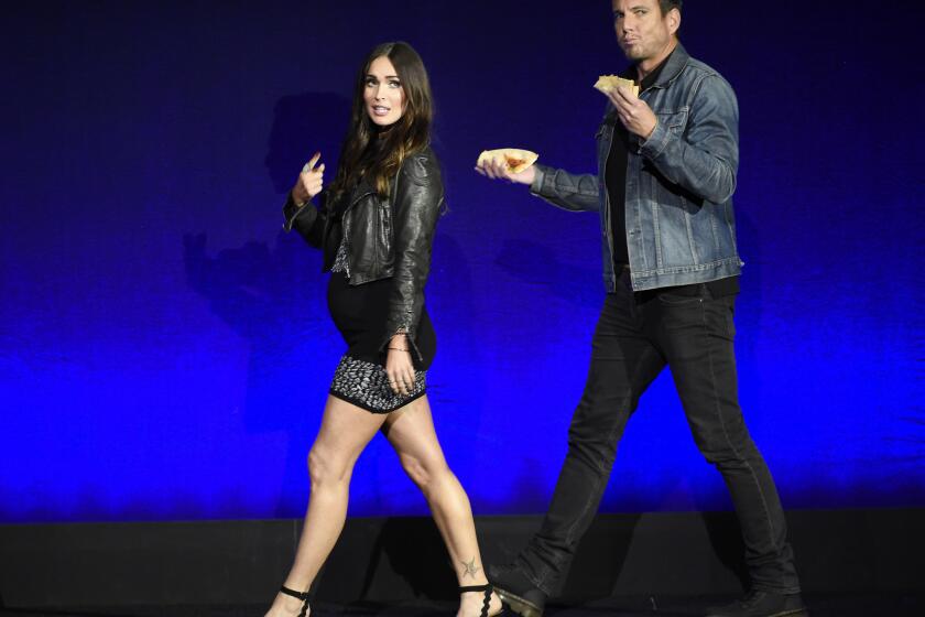 Megan Fox and Will Arnett, cast members in the upcoming film "Teenage Mutant Ninja Turtles: Out of the Shadows," take the stage during the Paramount Pictures presentation at CinemaCon 2016.