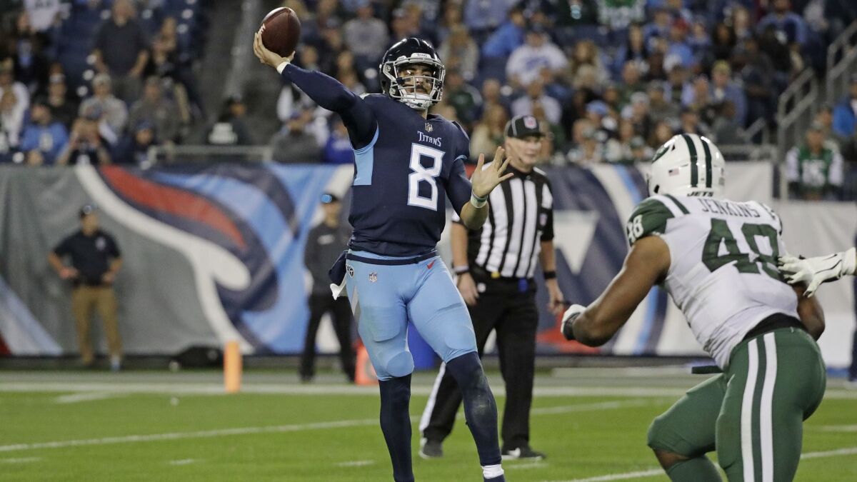 Tennessee Titans quarterback Marcus Mariota (8) passes as he is pressured by New York Jets outside linebacker Jordan Jenkins (48).