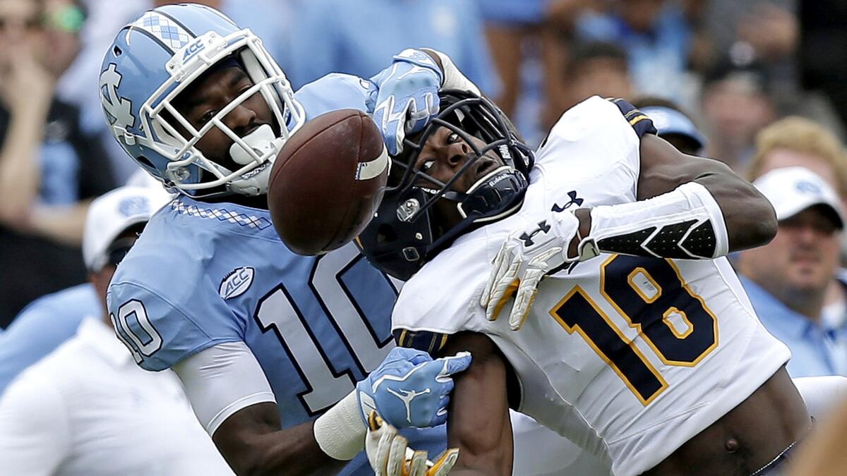 North Carolina defensive back Andre Smith breaks up a pass intended for California's Marloshawn Franklin Jr. (during the first half Saturday.