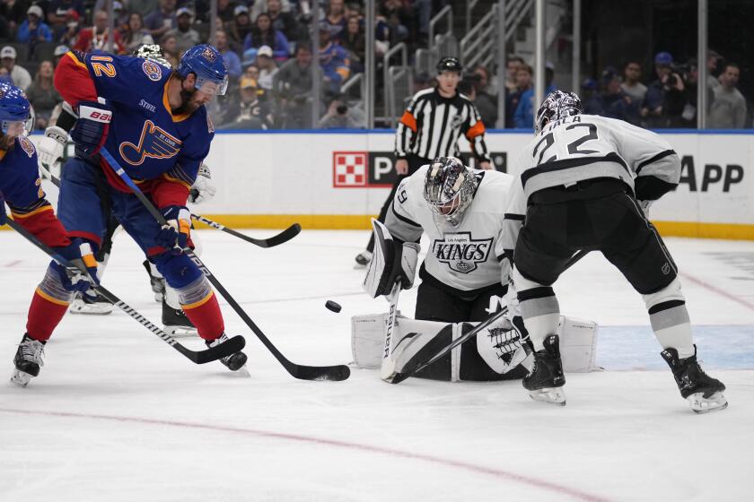 St. Louis Blues' Kevin Hayes (12) is unable to score past Los Angeles Kings goaltender Cam Talbot (39) and Kevin Fiala (22) during the second period of an NHL hockey game Wednesday, March 13, 2024, in St. Louis. (AP Photo/Jeff Roberson)