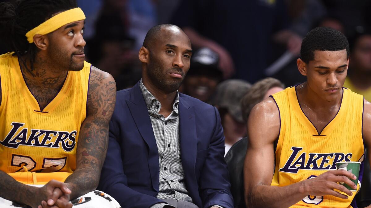 Lakers teammates (from left) Jordan Hill, Kobe Bryant and Jordan Clarkson sit on the bench during a win over Detroit Pistons at Staples Center on March 10.