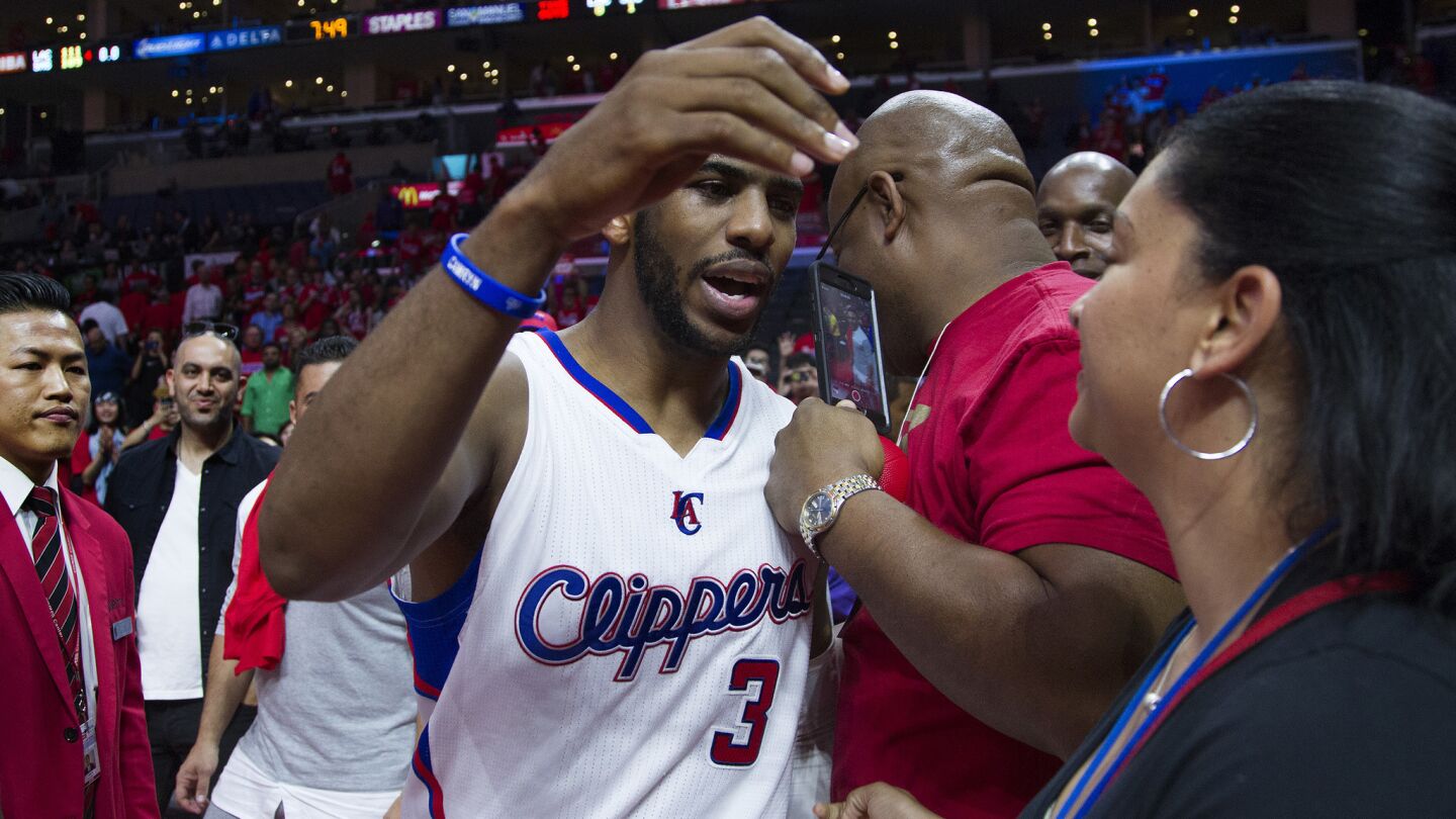 Clippers point guard Chris Paul hugs a fan after the team's 111-109 victory over the San Antonio Spurs in Game 7 of the Western Conference quarterfinals at Staples Center on May 2, 2015.
