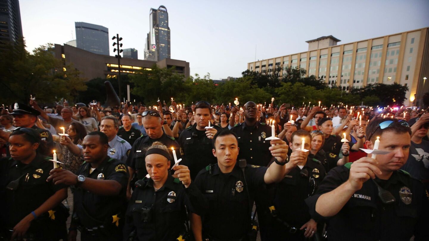 Police officers take part in the "Dallas Strong" candlelight vigil at City Hall on July 11, 2016, in honor of the five Dallas police officers killed last week.