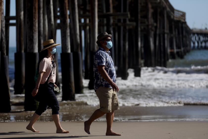 VENTURA, CA -- APRIL 25: Visitors practice social distancing at the beach on Saturday, April 25, 2020, in Ventura, CA. Los Angeles County's beaches along its 72 mile coast remain closed this weekend due to the coronavirus. But beaches in neighboring Ventura and Orange County are open. (Gary Coronado / Los Angeles Times)