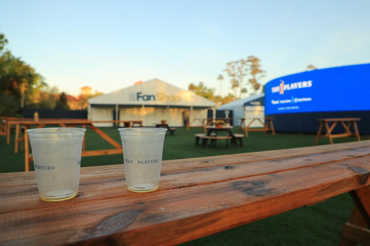 Two empty cups are seen on a table in an empty fan area after the cancellation of the The PLAYERS Championship at TPC Sawgrass on March 13.