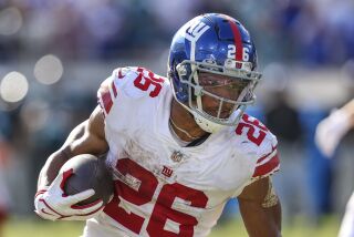 New York Giants running back Saquon Barkley (26) runs the ball during an NFL football game against the Jacksonville Jaguars on Sunday, Oct. 23, 2022, in Jacksonville, Fla. (AP Photo/Gary McCullough)
