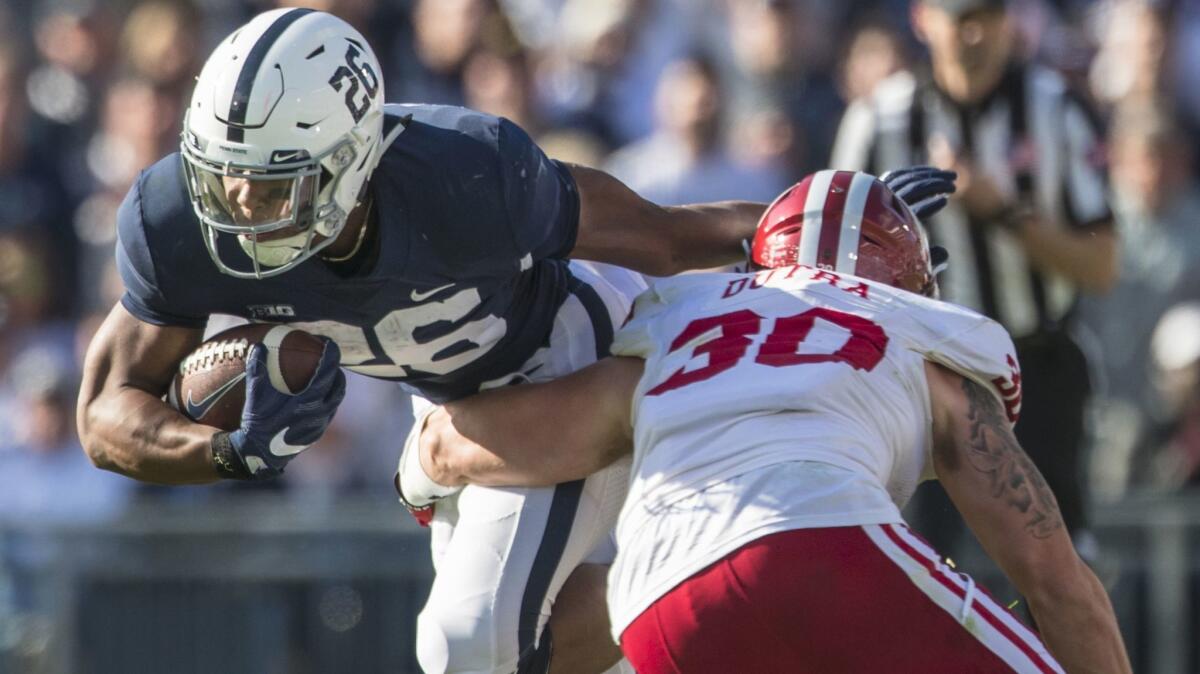 Penn State's Saquon Barkley breaks a tackle by Indiana's Chase Dutra on Sept. 30.