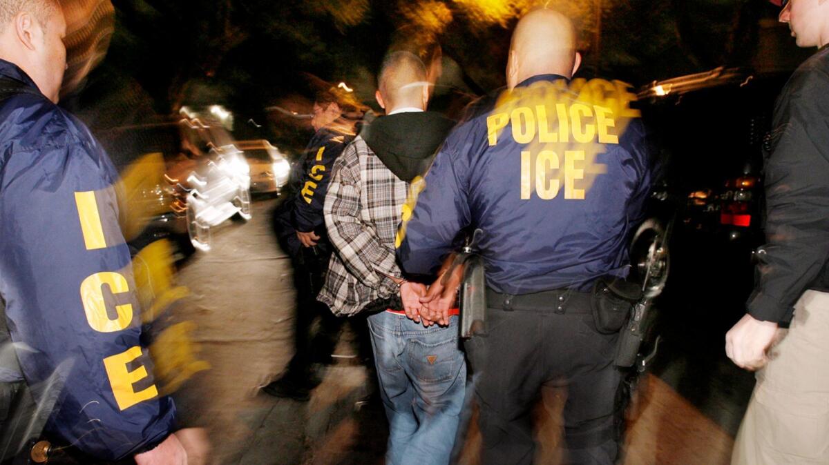 Immigration agents during a pre-dawn raid in Santa Ana earlier this year. In a separate arrest last year, a U.S. citizen was mistakenly detained and spent several days in a detention facility before immigration authorities realized their mistake and halted attempts to deport him.